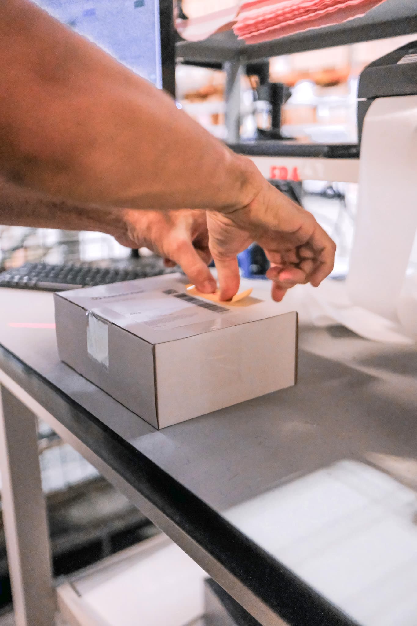 A shipping label being applied to  3PL order packaging