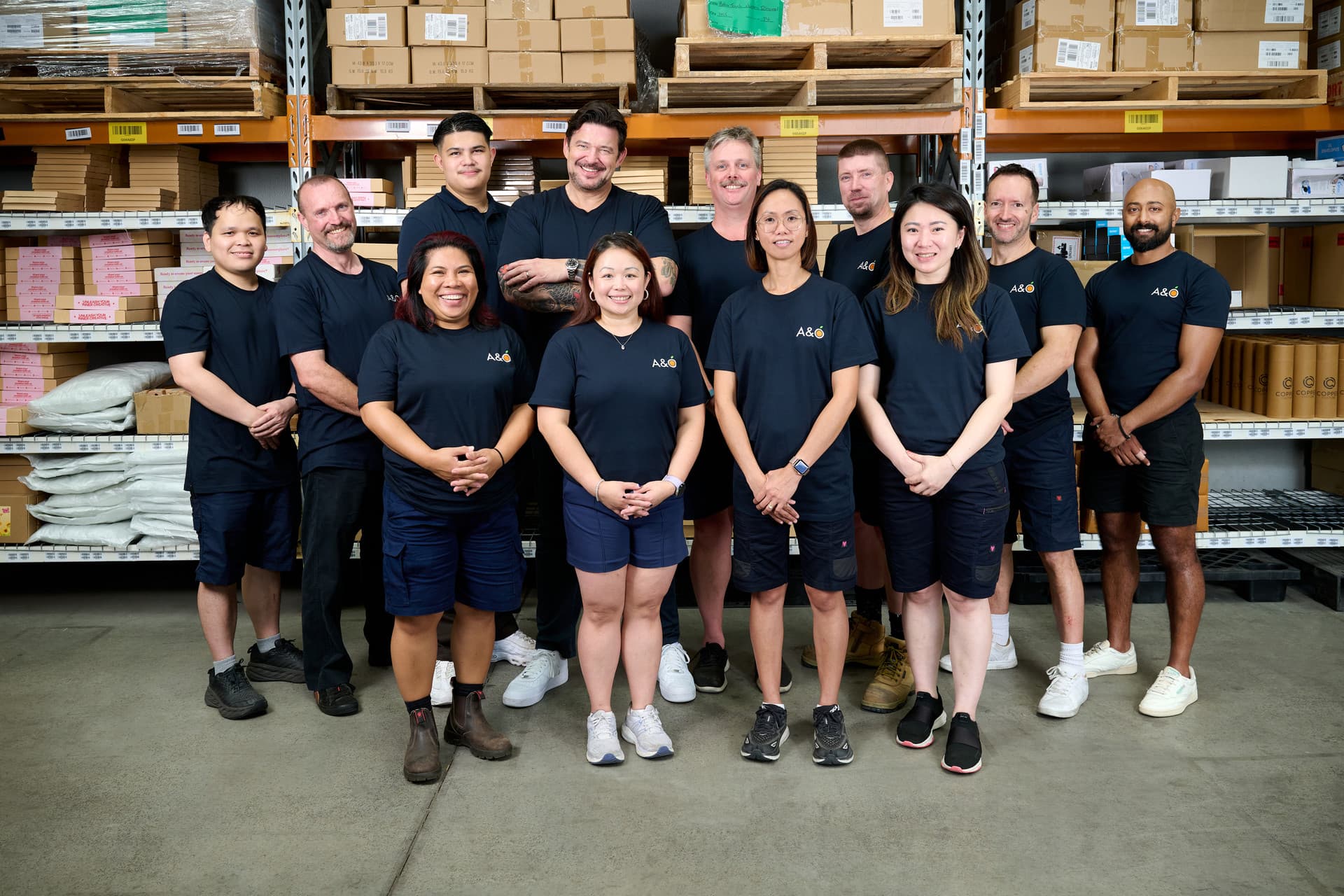 Photograph of the 3PL Warehouse team gathered in the storage facility